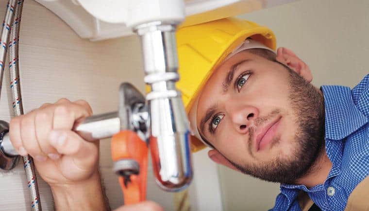 Guy removing drain pipe